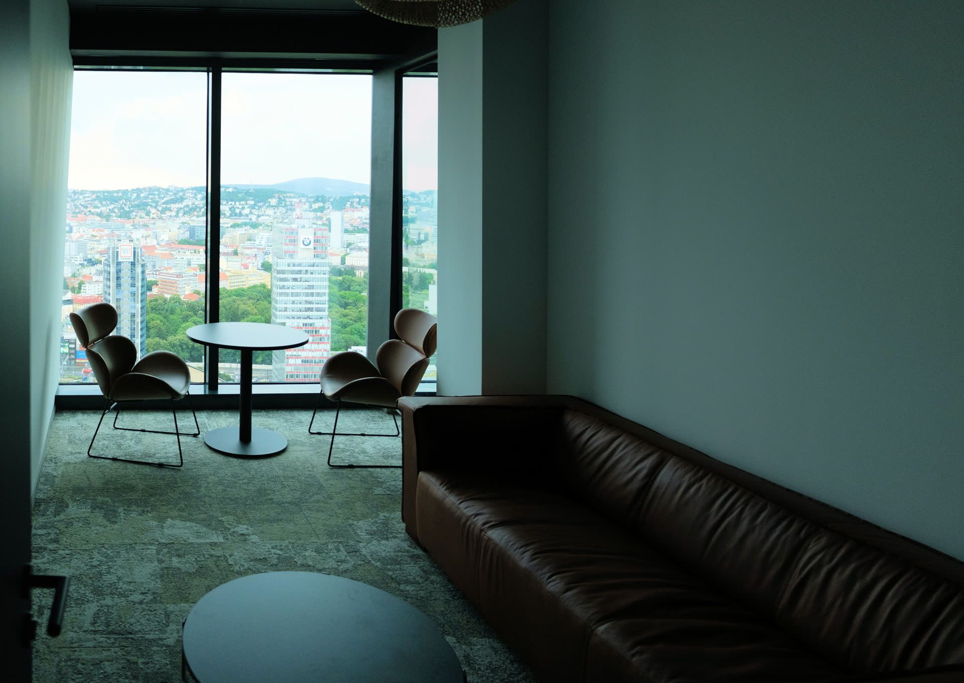 Lounge with a leather sofa and a city view